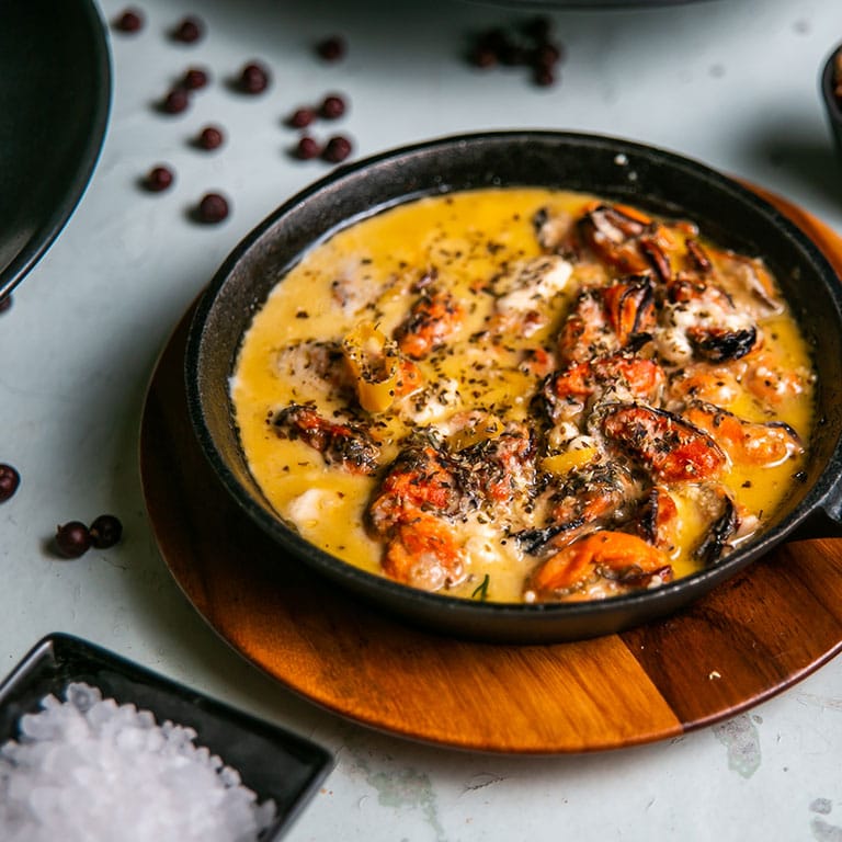 Shrimp saganaki in tomato sauce, served in a small iron pan